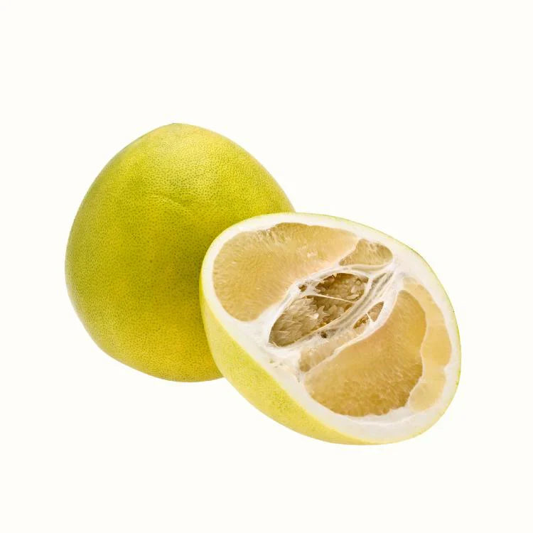 Pomelo fruit close-up showing thick rind and pale citrus flesh