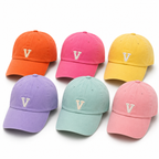 Six colorful baseball caps with a letter 'V' on a white background