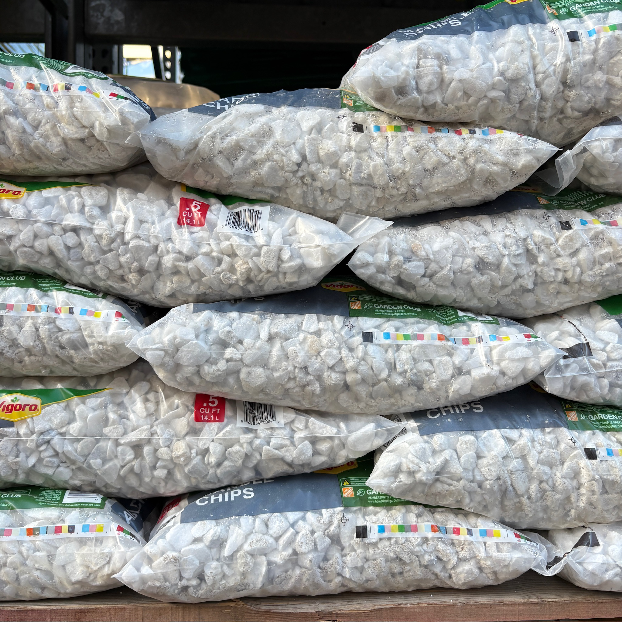 Stack of bags of chips with visible brand labels.