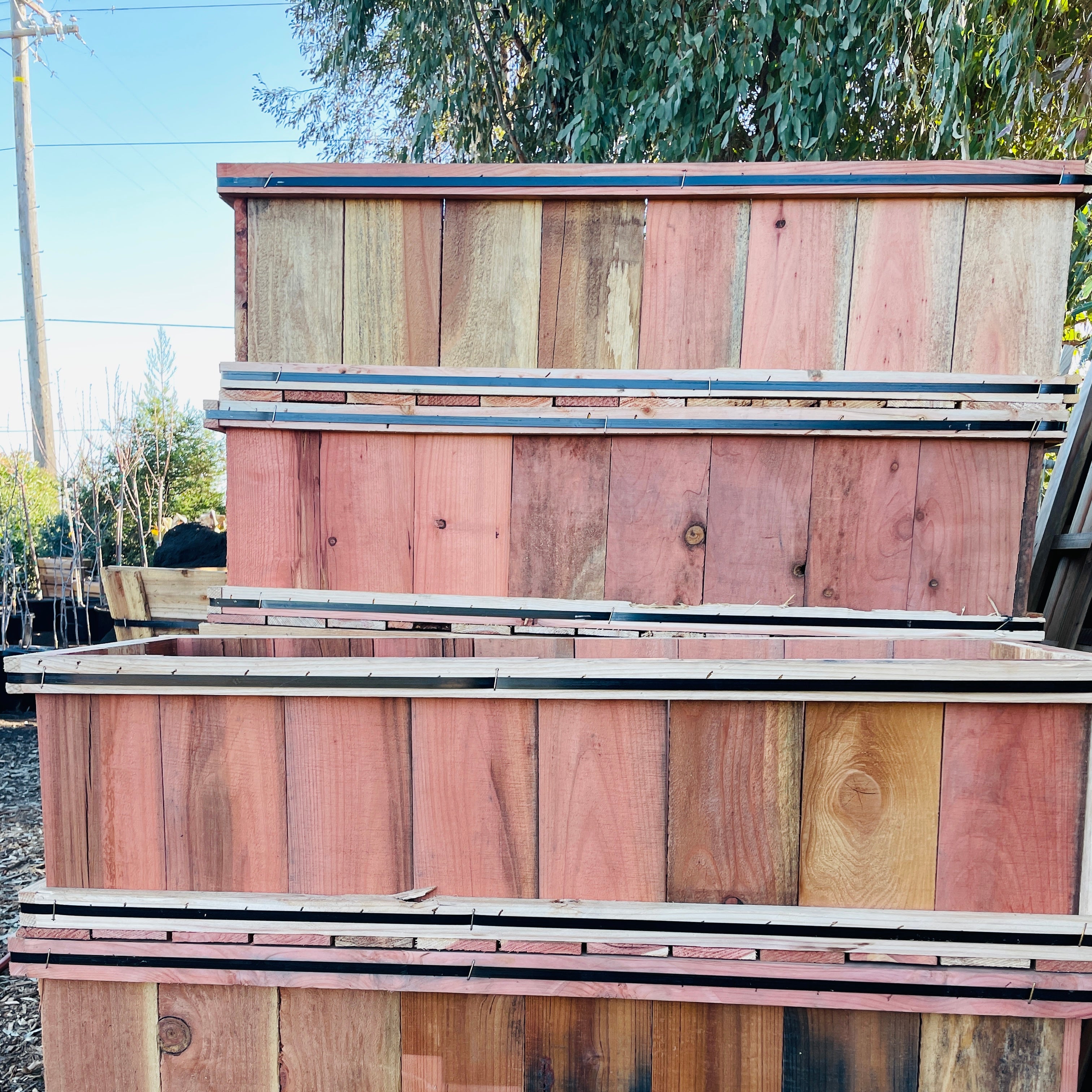 Stack of wooden planks with a natural wood finish outdoors